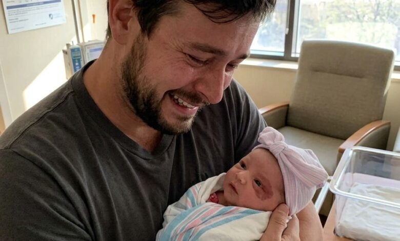 My Husband Froze When He Saw Our Newborn Daughter — Then He Pointed Behind Her Ear and Told Me the Truth
